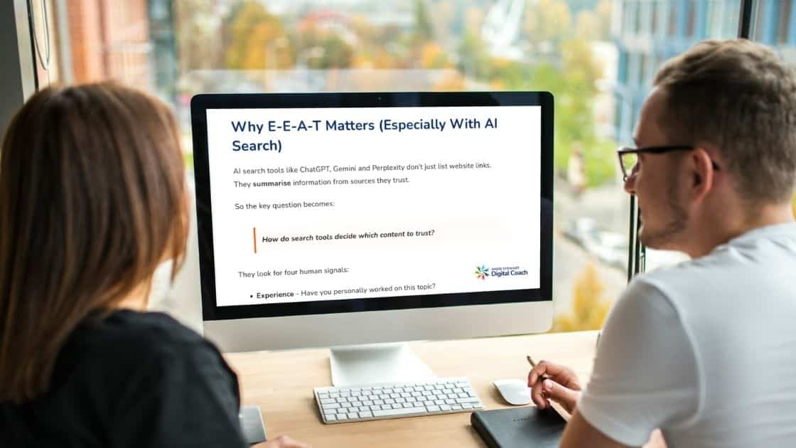 What Is E-E-A-T 2 business people looking at a PC screen about What is E-E-A-T